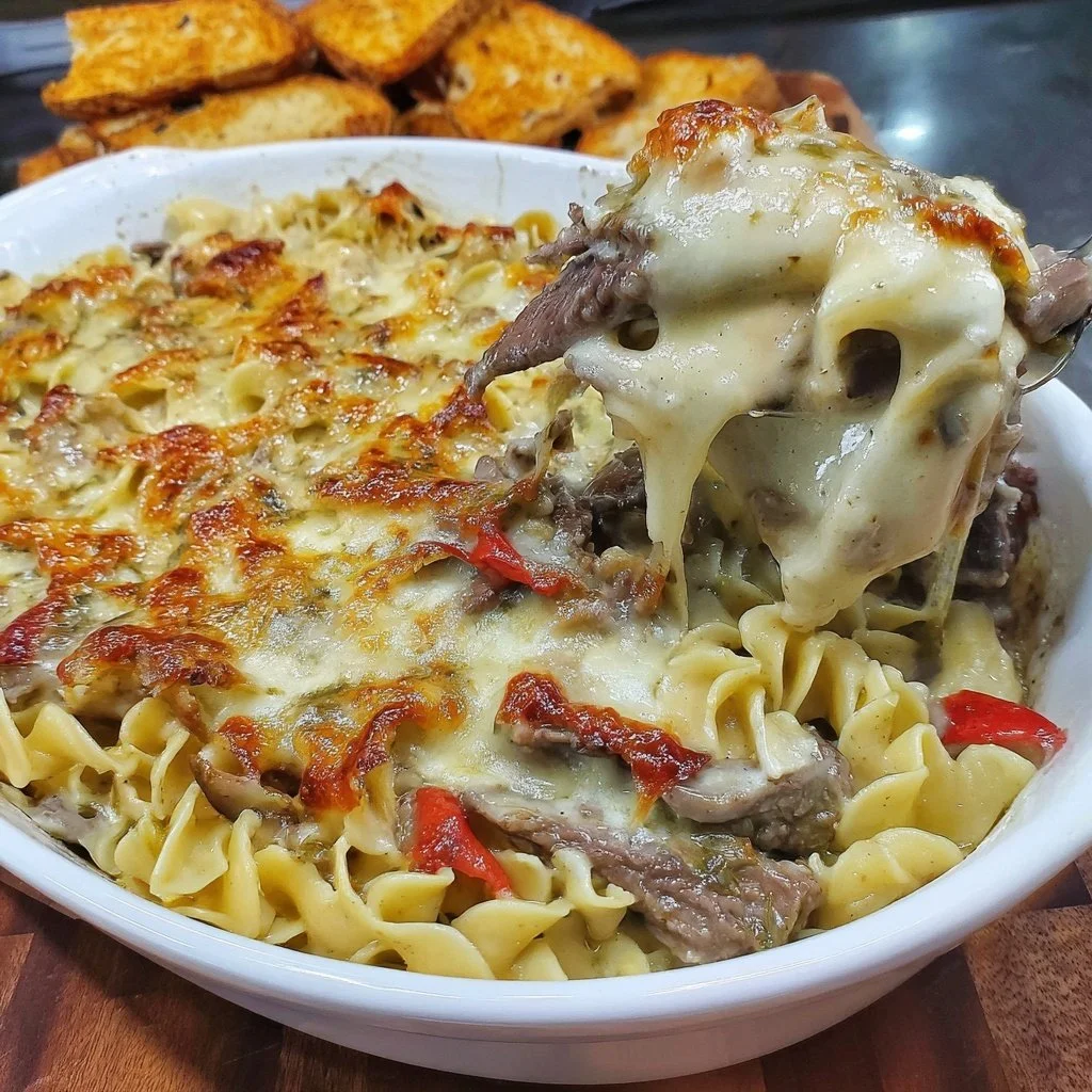 Philly Cheesesteak Casserole showcasing layers of beef, cheese, and peppers.