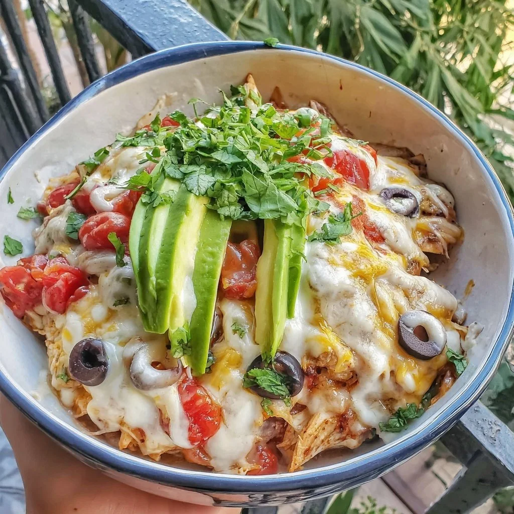 A delicious spring chicken burrito bowl casserole topped with fresh ingredients.