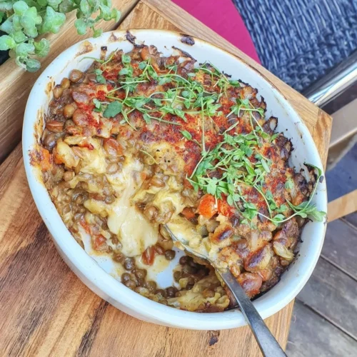 Green lentil and carrot casserole with cumin spice served in a bowl
