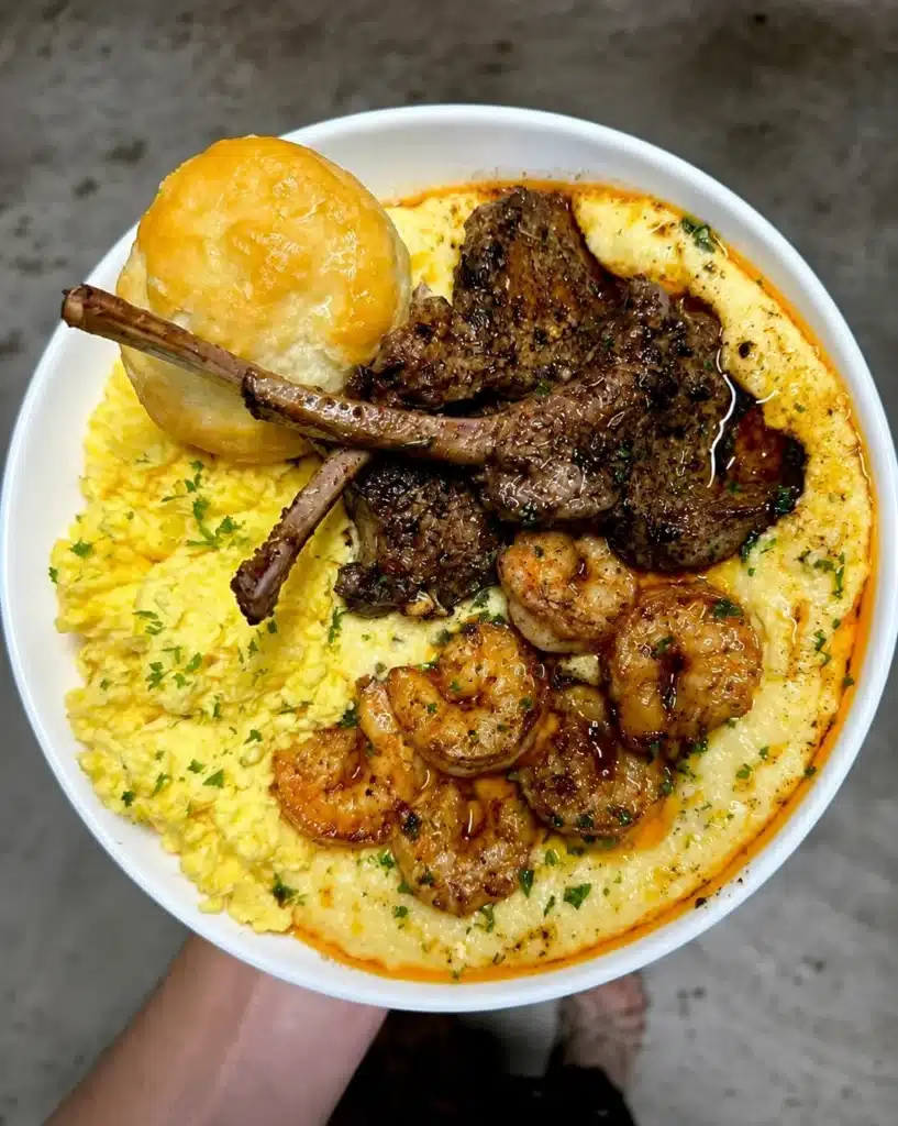 Jalapeno cheddar grits with Cajun honey butter lamb chops and shrimp with cheesy eggs and a buttermilk biscuit