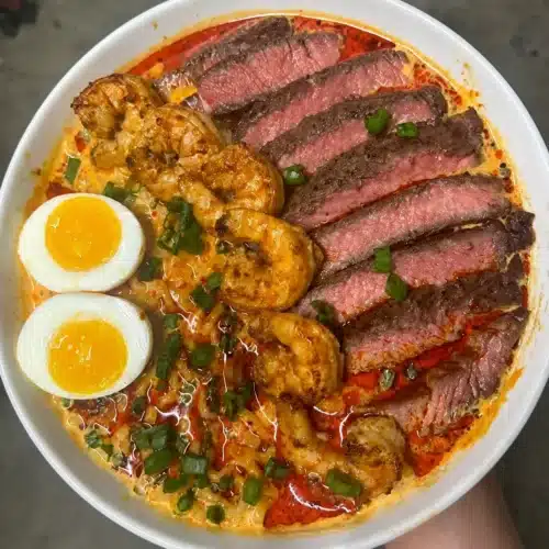 Delicious steak and shrimp ramen served in a bowl with chopsticks