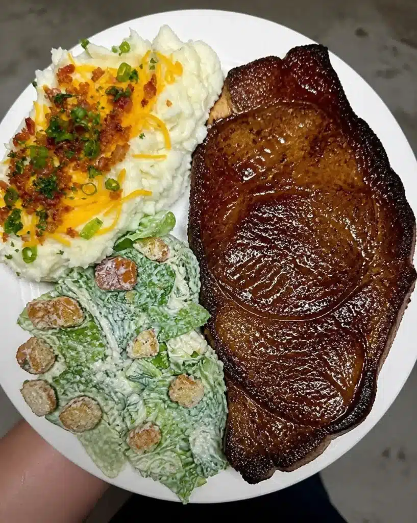 T-Bone with loaded mashed potatoes and a caesar salad